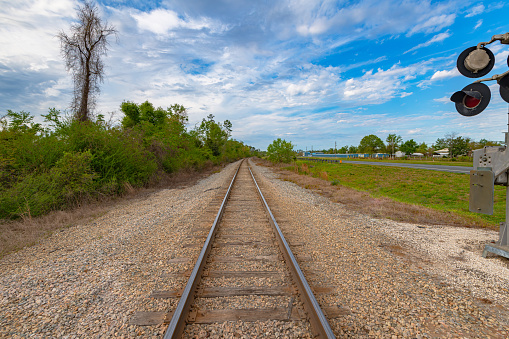 landscape of railroad tracks with cloudy blue sky