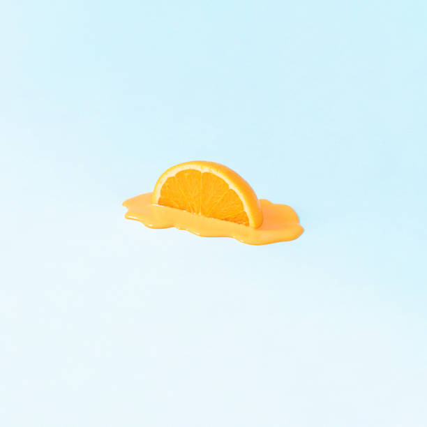 istock Creative summer idea with halved orange fruit on bright background. 1309932536
