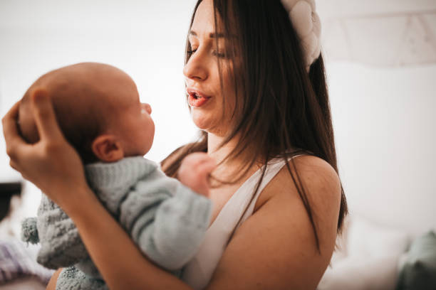 istock Happy mother playing with her baby 1309933192
