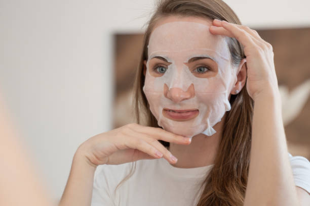 istock Young woman doing purifying mask on her face 1309933339