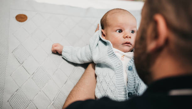 istock Smiling handsome father carrying cute son at home 1309933593