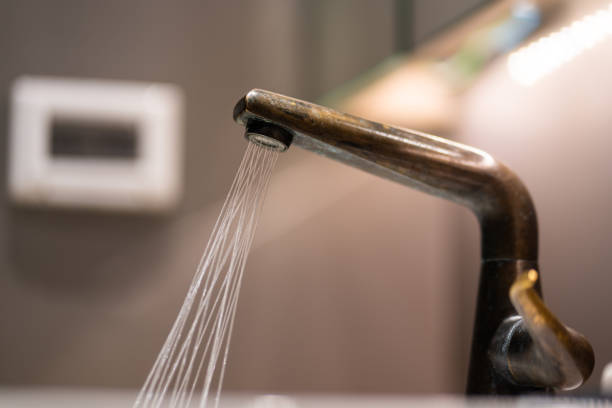 istock Water flowing out from sink faucet. 1309934887