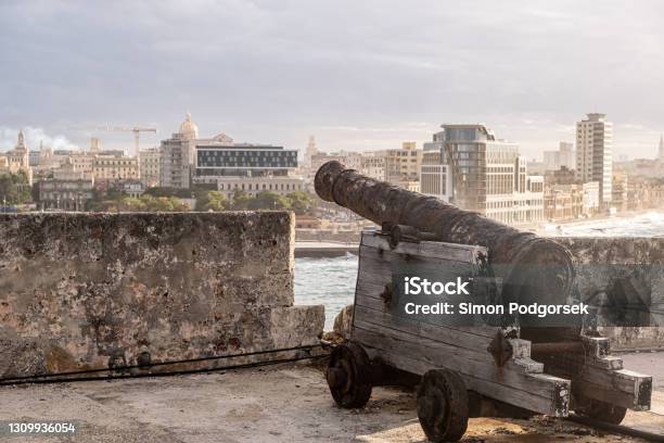 Old Rusty Cannon Against Havana Skyline Buildings In Cuba At Sunny Day Stock Photo - Download Image Now