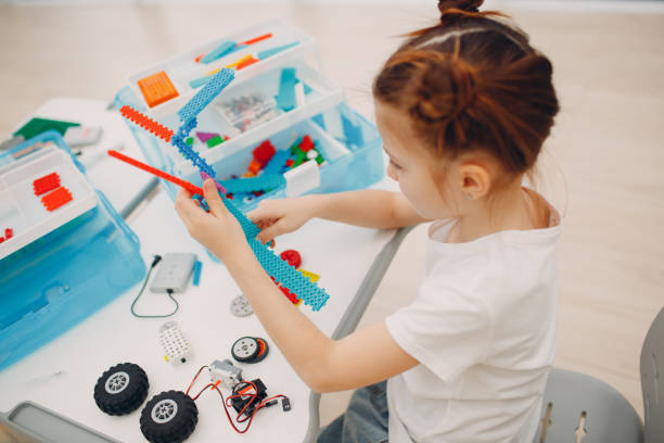 Smiling kid little girl child constructor checking technical toy. Children Robotics constructor assemble robot. Smiling kid little girl child constructor checking technical toy. Children Robotics constructor assemble robot robotics photos stock pictures, royalty-free photos & images