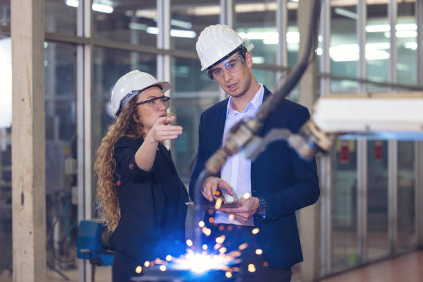 istock Engineer supervising autonomous production process industry robot arm in factory 1309937347