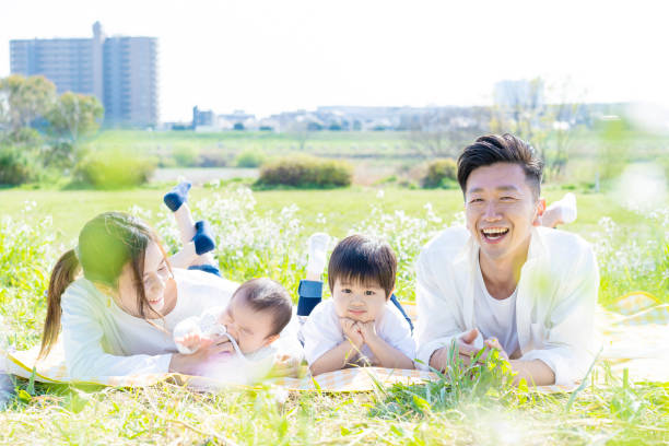 istock Family lying side by side in the green space 1309937359