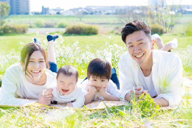 istock Family lying side by side in the green space 1309937407