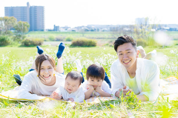 istock Family lying side by side in the green space 1309937454