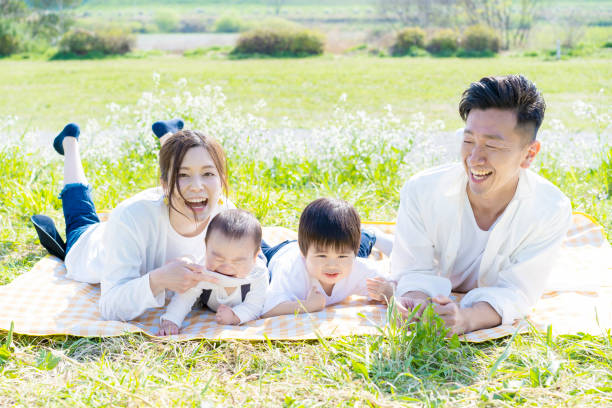 istock Family lying side by side in the green space 1309937505