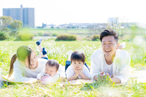 istock Family lying side by side in the green space 1309937543