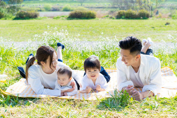 istock Family lying side by side in the green space 1309937626