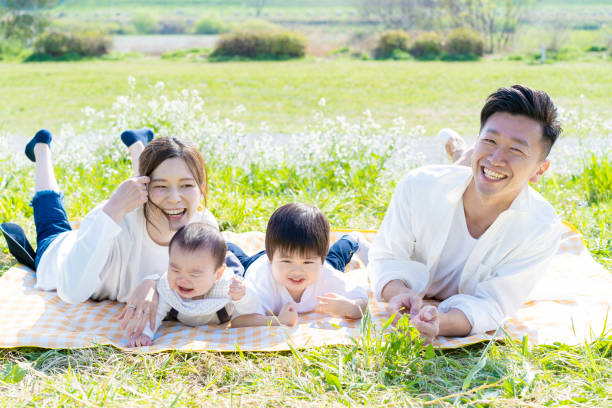 istock Family lying side by side in the green space 1309937671