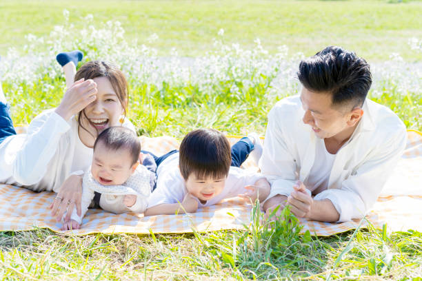 istock Family lying side by side in the green space 1309937720