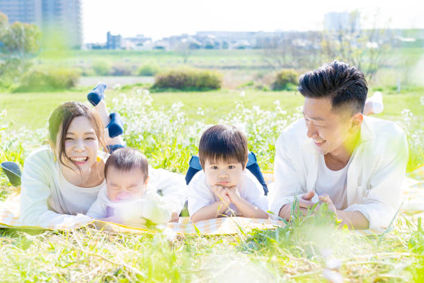 istock Family lying side by side in the green space 1309937786