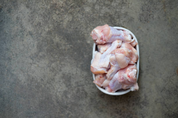 istock Fresh chicken drumsticks meat in white bowl. 1309937953