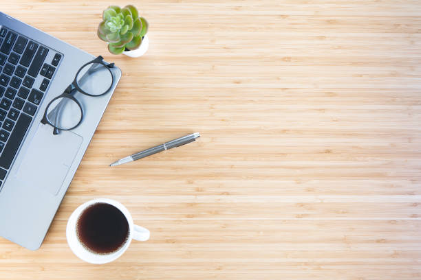 istock flat lay composition with notebook, pen, coffee, plant, laptop on wood background. top view 1309939505