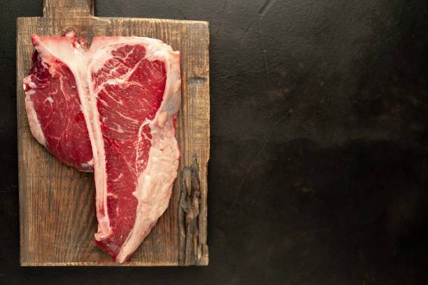 istock Grilled T-bone steak on a stone table. With rosemary and spices. 1309939555