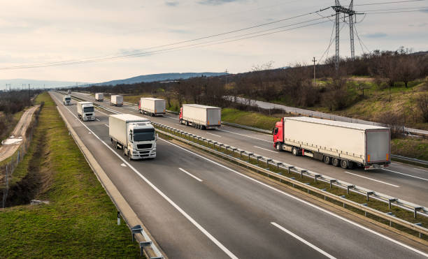 istock Convoys of transportation trucks passing on a highway 1309940570