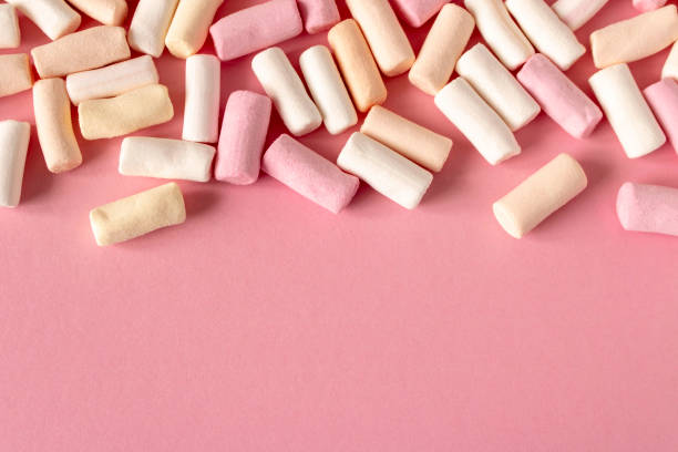 istock Colorful marshmallows on a pink background. Close-up. Selective focus. 1309940648