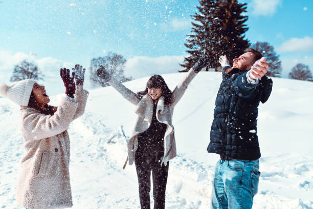 istock Friends Spreading Snow Around And Having Fun 1309940744