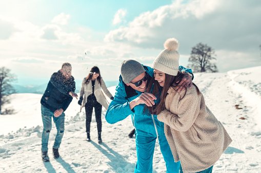 Couples Fighting With Snow As Fun On Mountain