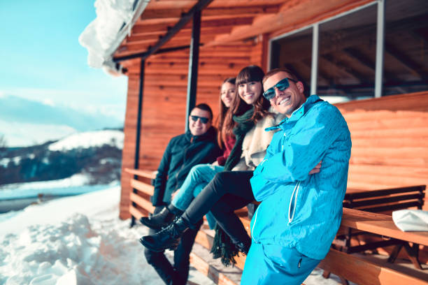 istock Couples Enjoying Mountain Snow Fun While Spending Time At Winter Cottage 1309941682