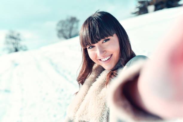 istock Snow Selfie By Cute Smiling Female 1309942256