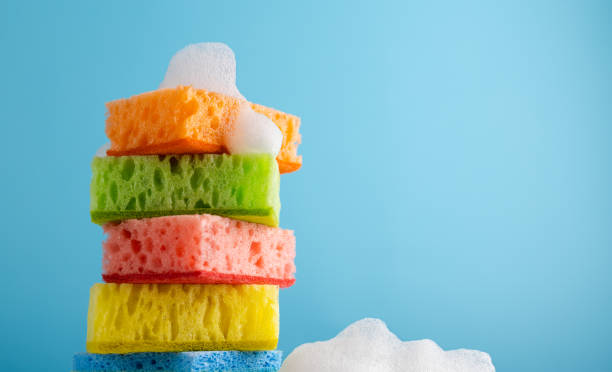 istock Household Cleaning Scrub Colored Sponges. Kitchen Dishwashing Sponge on blue background. Cleaning home concept. 1309944346
