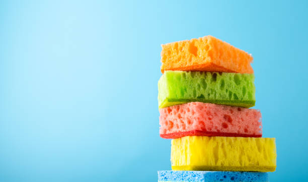 istock Household Cleaning Scrub Colored Sponges. Kitchen Dishwashing Sponge on blue background. Cleaning home concept. 1309944352