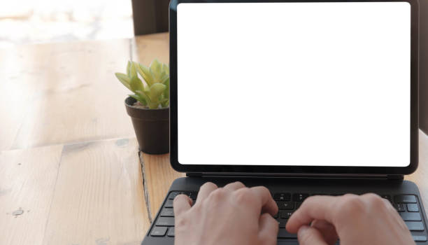 istock Mockup image of a woman using and typing on laptop computer with blank white desktop screen 1309944540