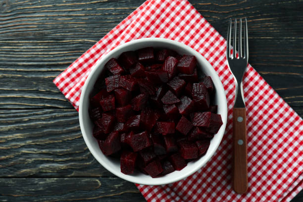 istock Bowl with beet salad, fork and kitchen towel on wooden background 1309946129