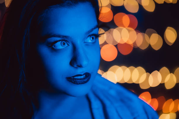 istock Sensual redhead woman in front of lights 1309946337