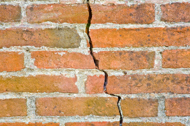 istock Old wall built with bricks cracked and damaged due to structural failure 1309946758