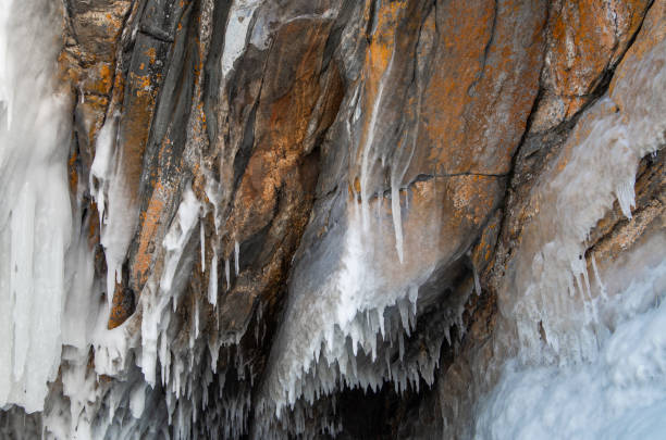 istock Background texture, detailed surface of rocks covered with snow and ice icicles 1309947496