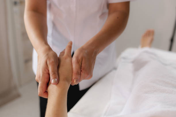 istock Unrecognizable women in a spa. Therapist making relaxing palm hand massages. 1309947512