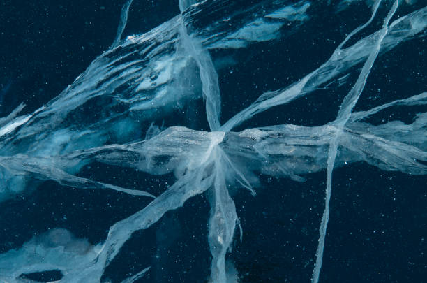 istock Cracks in a thick solid layer of ice on frozen Lake Baikal. 1309947597