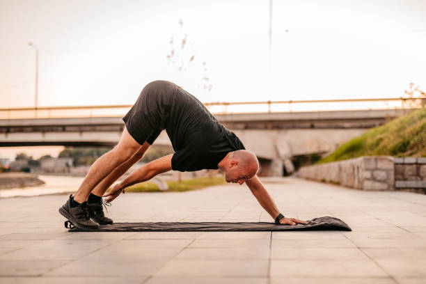 istock Athlete man warming up before training outdoors 1309947765