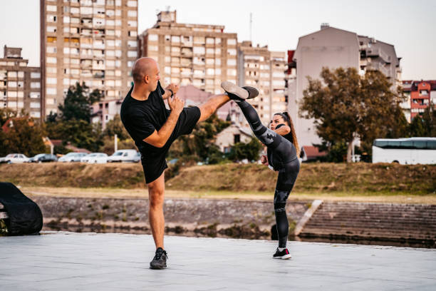 istock Man and a woman practice kick boxing 1309948198