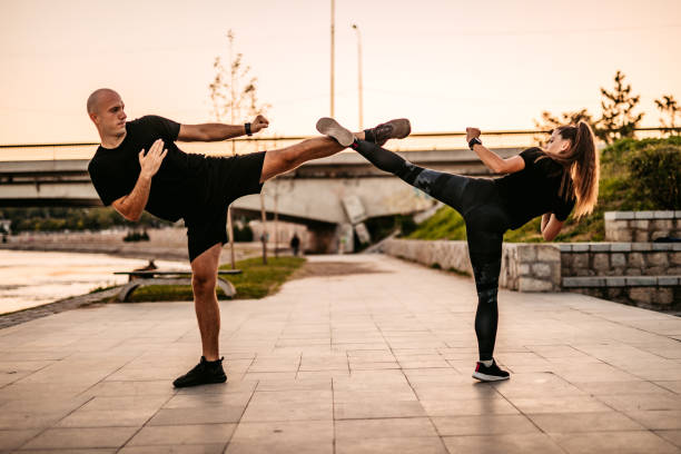 istock Man and a woman practice kick boxing 1309948408