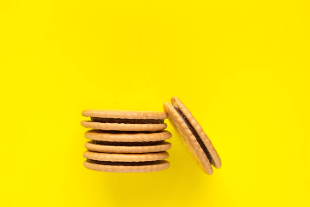 istock Sandwich biscuits with a chocolate filling on a yellow background. 1309949105