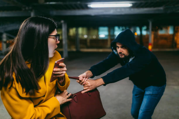 istock Purse snitcher robbing a woman 1309949885