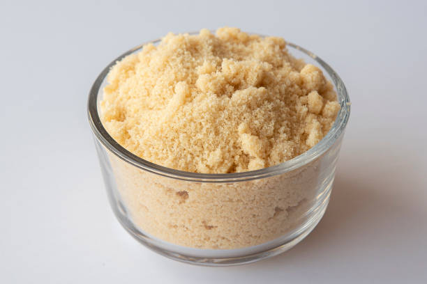 istock Brown sugar in a bowl on white background 1309950953