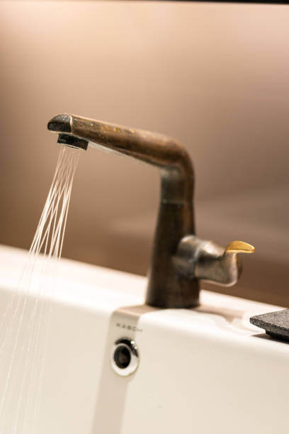 istock Water flowing out from sink faucet. 1309951309