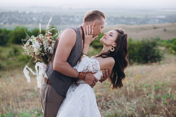 istock Couple in boho style in nature hug each other. Boho style wedding. 1309952110