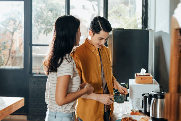 istock Two Young Colleagues Making Coffee and Enjoying a Pleasant Conversation 1309952402