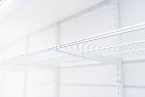 istock Wire shelves of open bright closet with top lighting 1309957375