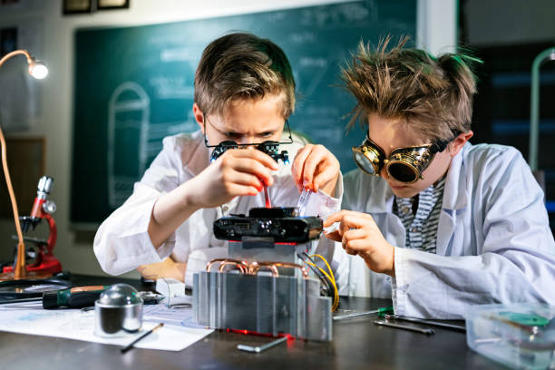 Schoolgirl and schoolboy doing experiment on a school science class.