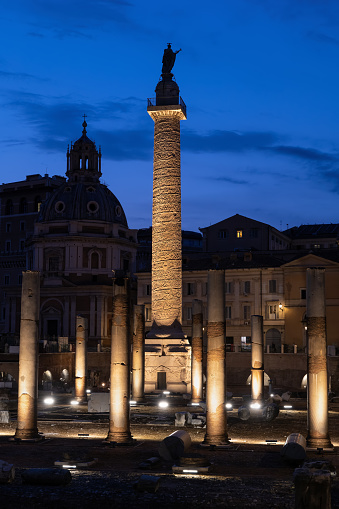 Trajan Column (113 AD) and columns at Trajan Forum (Foro di Traiano) at night in Rome, Italy