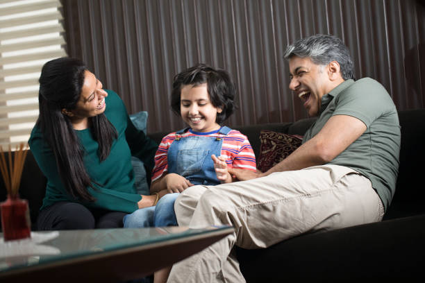 istock Daughter having fun with parents at home 1309961671