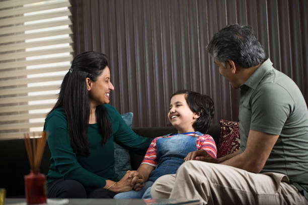 istock Daughter having fun with parents at home 1309961901